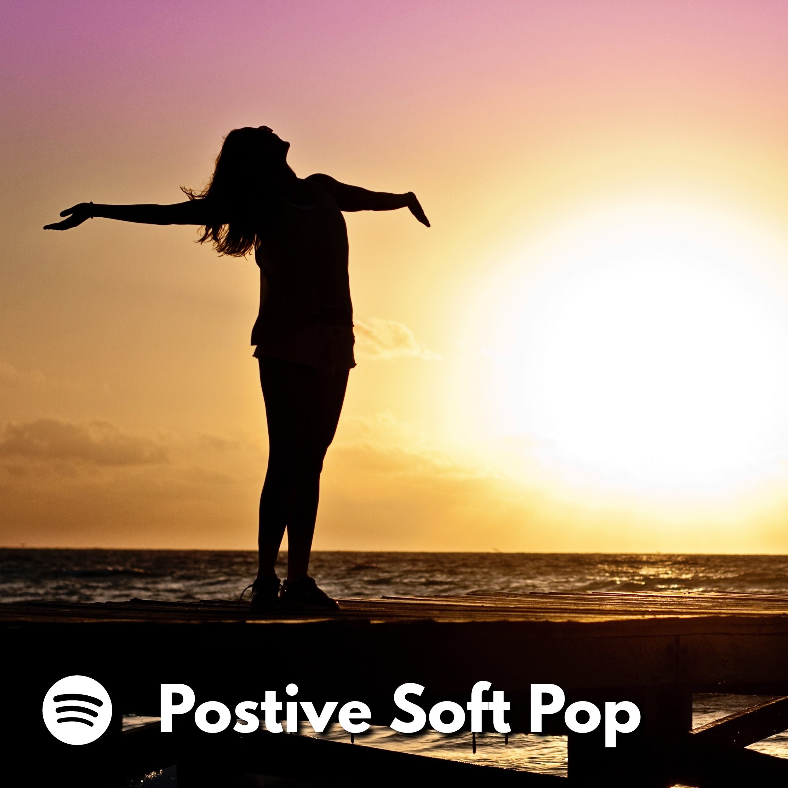 Silhouette of a woman with outstretched arms facing up toward the sky at sunset